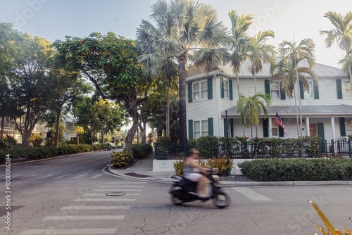 person on motorscooter and residential house in  Key West, Florida, United States. photo