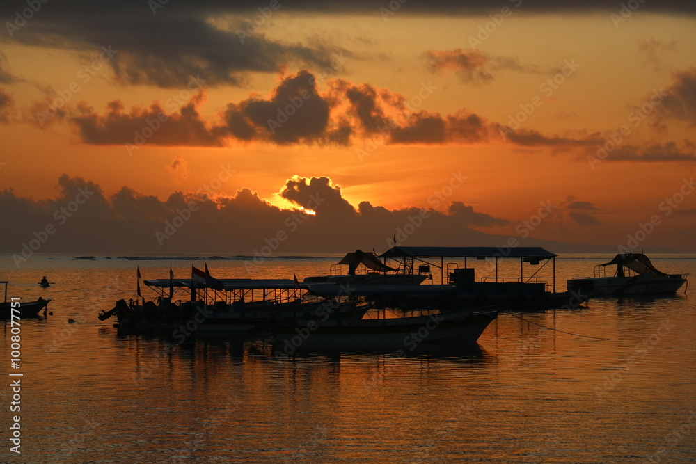 stunning sunset in Tanjung Benoa Beach Bali. Calm sea, silhouette of a fishing boat, Nature Background. stunning sunset in Tanjung Benoa Beach Bali. Calm sea, silhouette of a fishing boat, Nature Background.