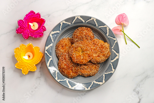 Anarsa is a popular Indian sweet made from rice, sugar, ghee, and poppy seeds. Traditionally part of Diwali Faral, Anarase is a crisp, rice based pastry enjoyed during the festive season. copy space. photo