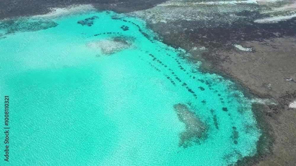 Aerial shot of bright turquoise atoll lagoon with coral formations. Maafushi, Maldives. Aerial shot of bright turquoise atoll lagoon with coral formations. Maafushi, Maldives.