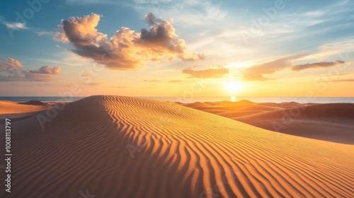 A beautiful sunrise over the sand dunes of Mui Ne, with golden light casting shadows over the rippled sand.