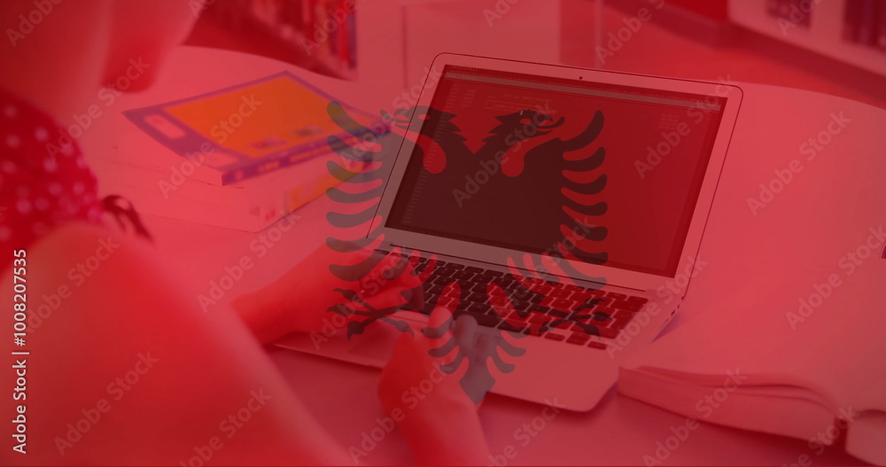 Obraz premium Image of flag of albania over caucasian businesswoman using laptop