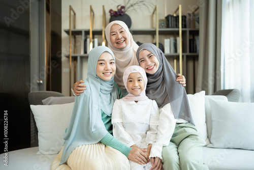 Portrait of happy multi-generation muslim family in a living room at home