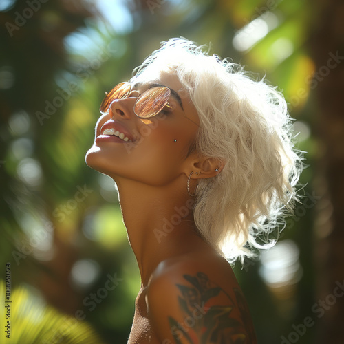 side profile portrait of a happy woman with face tattoos and piercings breathing fresh air smiling outdoors 