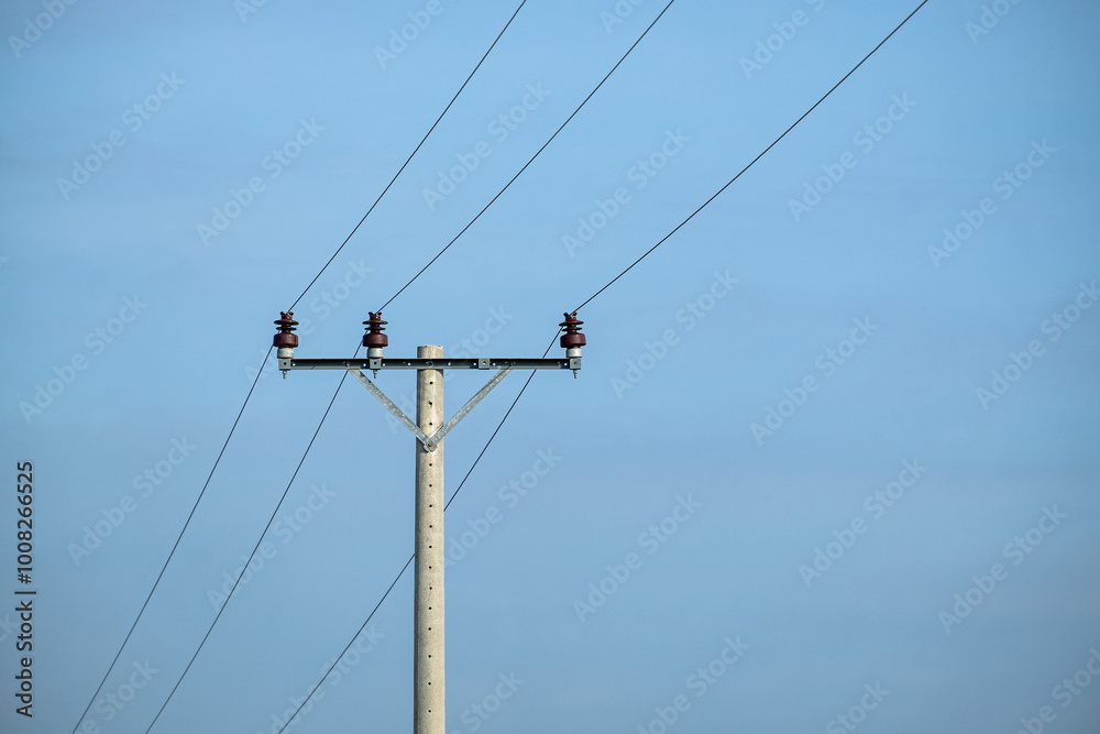 A small utility electric pole in a rural village with the sky as the background A small utility electric pole in a rural village with the sky as the background