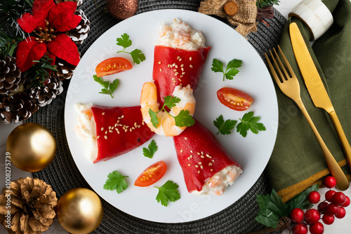 Red piquillo peppers stuffed with cod. Top view table with Christmas decoration. photo