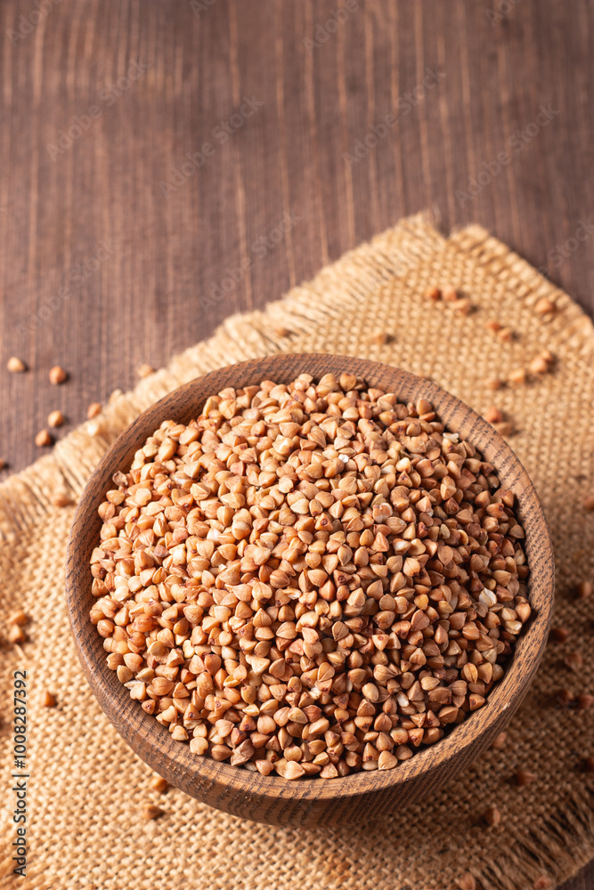 Buckwheat groats on wooden background. Healthy cereal concept Buckwheat groats on wooden background. Healthy cereal concept