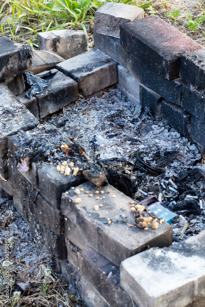 A fire pit that has been constructed using bricks set in the dirt A fire pit that has been constructed using bricks set in the dirt