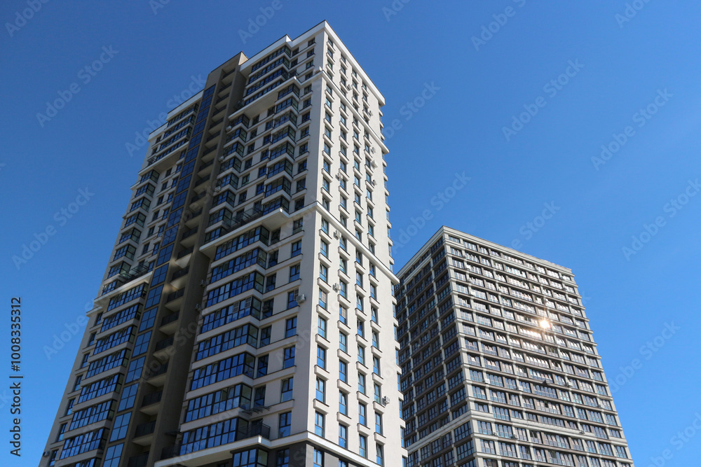 Modern high-rise skyscrapers against the blue sky. Multi-storey residential real estate. Modern high-rise skyscrapers against the blue sky. Multi-storey residential real estate.