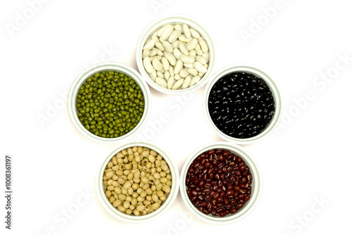 Black beans azuki beans, green beans, white beans and soybean in white cups, isolated on white background with clipping path top view flat lay. Diet and healthy food concept. photo