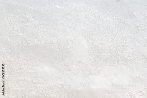 Front view of a clean and blank plastered wall painted in white on sunny day. Abstract high resolution full frame textured background with copy space.