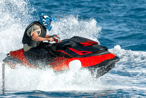 Pilot riding powerful watercraft at high speed on the ocean waves
