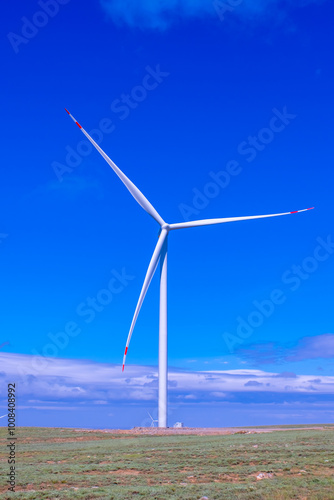 Fleet of power generators in motion. The blades of the wind farm rotate against the sky. The concept of extracting electricity from renewable sources. Wind turbine to generate electricity. photo