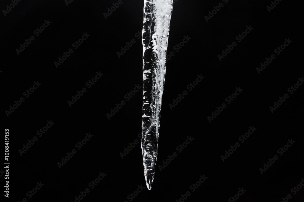 Elongated Crystal Icicle Stalactite Against Black Background Elongated Crystal Icicle Stalactite Against Black Background