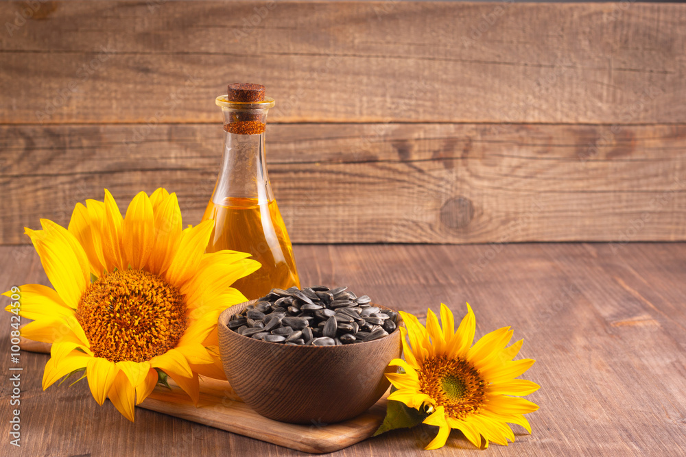Closeup photo of sunflower oil with seeds on wooden background. Bio and organic product concept. Closeup photo of sunflower oil with seeds on wooden background. Bio and organic product concept.