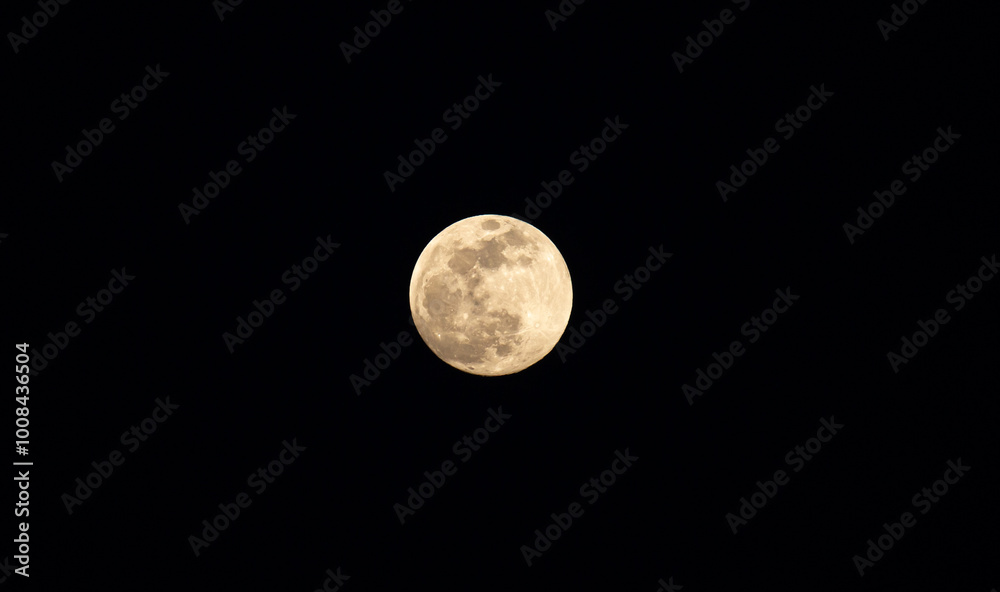 Full moon in the black sky. Close-up of the moon in the evening or night sky. Supermoon is an astronomical event. Full moon in the black sky. Close-up of the moon in the evening or night sky. Supermoon is an astronomical event.