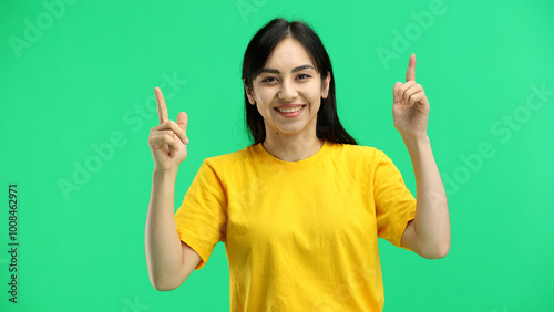 Woman, close-up, on a green background, pointing up