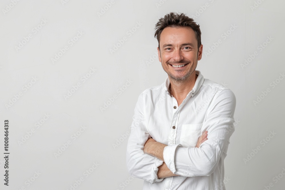 Portrait of a joyful man with arms folded, plain white background , background blur Portrait of a joyful man with arms folded, plain white background , background blur