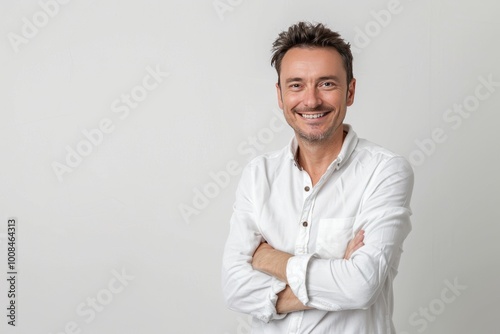 Portrait of a joyful man with arms folded, plain white background , background blur