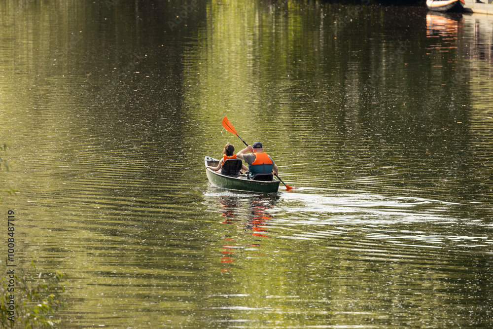 Father and daughter canoeing on calm river in UK for a summertime adventure Father and daughter canoeing on calm river in UK for a summertime adventure