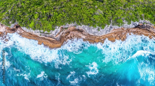 High-angle drone shot of a coastal cliff with crashing waves far below, showcasing natural beauty and dange photo