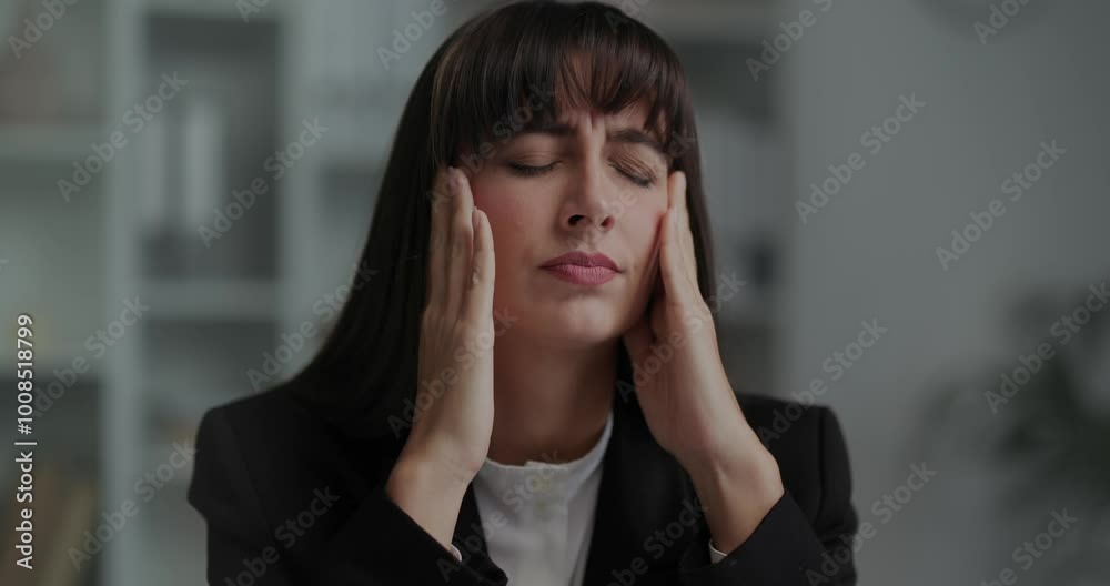 Unhappy young woman sitting at desk in office, suffer from anxious problems. Unhappy young woman sitting at desk in office, suffer from anxious problems.