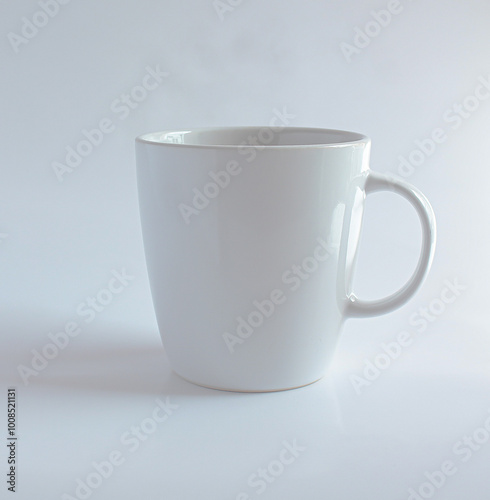 plain white ceramic mug with a simple handle. It has a clean and minimalistic design, perfect for enjoying coffee, tea, or any other hot beverage.