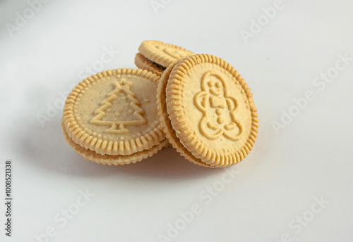 Round cookies with including Christmas symbols such as trees, snowmen and other holiday characters. Vanilla or butter sandwich cookies.