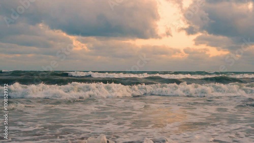 Sunrise Sea Waves Sandy Beach Sotf Yellow Sky Cumulus Lilac Gray Clouds Time Lapse. Beautiful Waves in the Ocean Colorful Cloudy Sky Sun Timelapse Coast Travel Vacation Relax Beauty. photo