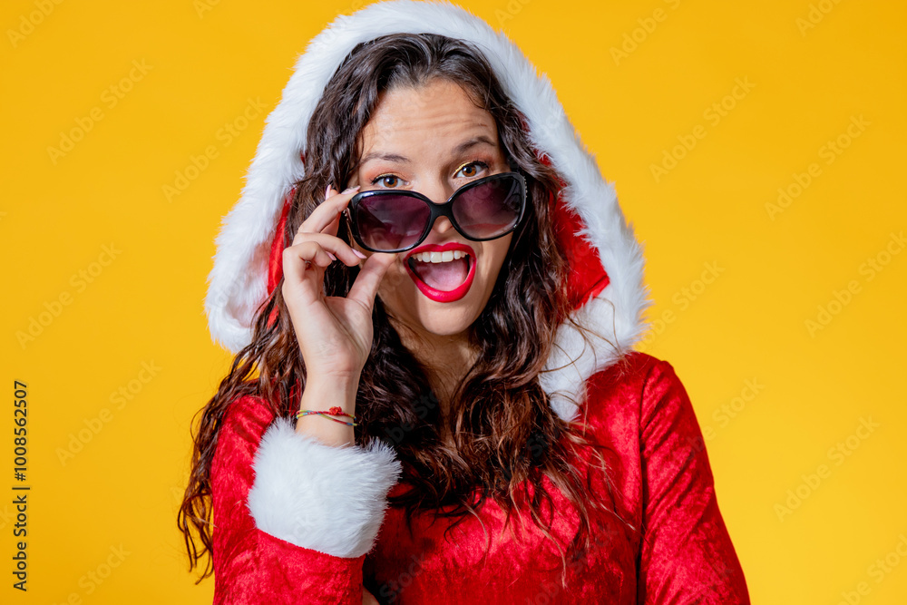 young woman wearing santa claus suit isolated with sunglasses young woman wearing santa claus suit isolated with sunglasses