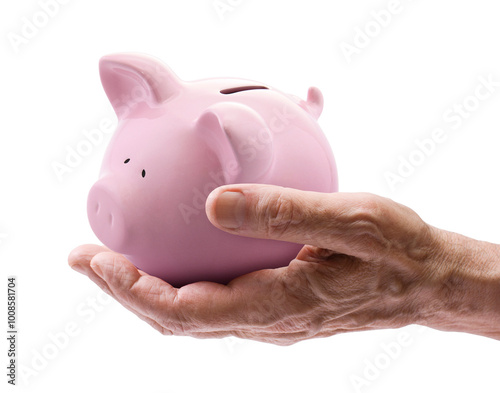 Fotografie Pink piggy bank in senior hand isolated on white background