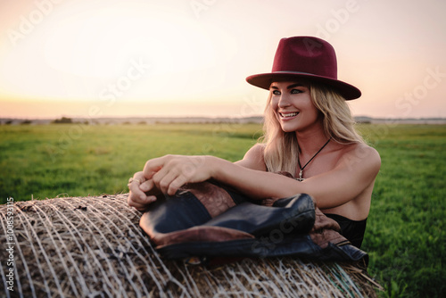 Cheerful Woman in Maroon Hat osing in a Field photo