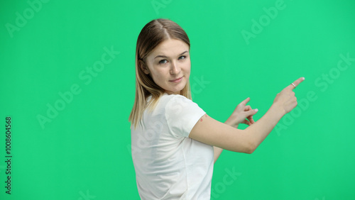 A woman, close-up, on a green background, shows forward