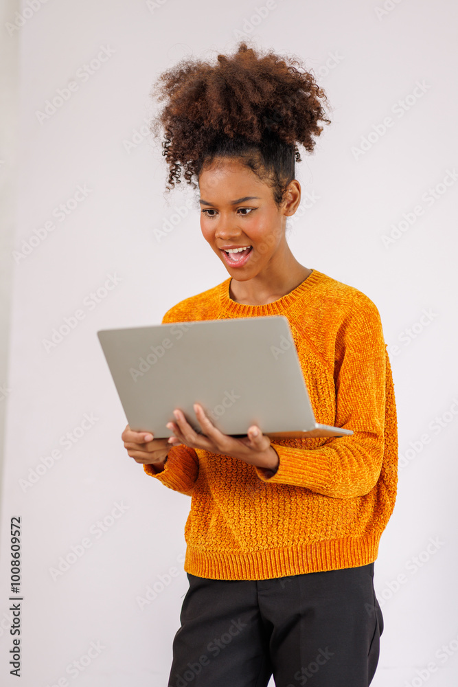 Portrait of stylish Happy african american woman in afro hair standing use laptop and posing on white background Portrait of stylish Happy african american woman in afro hair standing use laptop and posing on white background