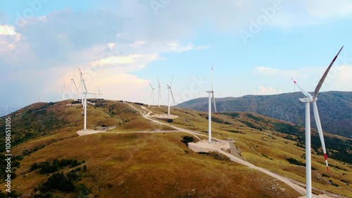 Majestic Aerial View of Remote Wilderness in Bosnia Herzegovina - Windmills, Scenic Valleys, and Rural Landscapes with Mountains, Meadows, and Tranquil Horizons in a Sunny, Dry Climate