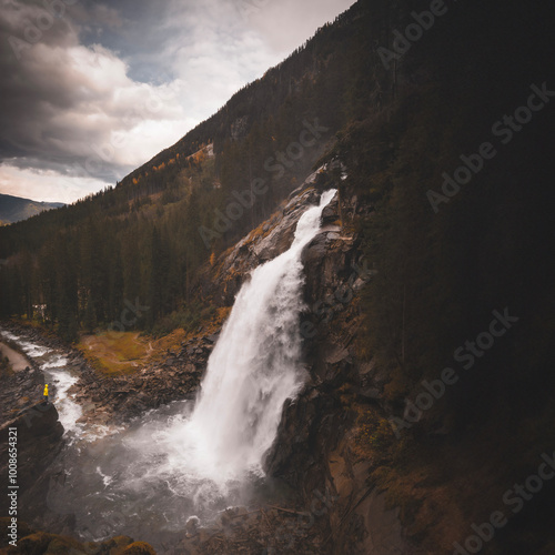 Tourist enjoys the view of the Krimml Waterfalls in High Tauern National Park Austria Alps