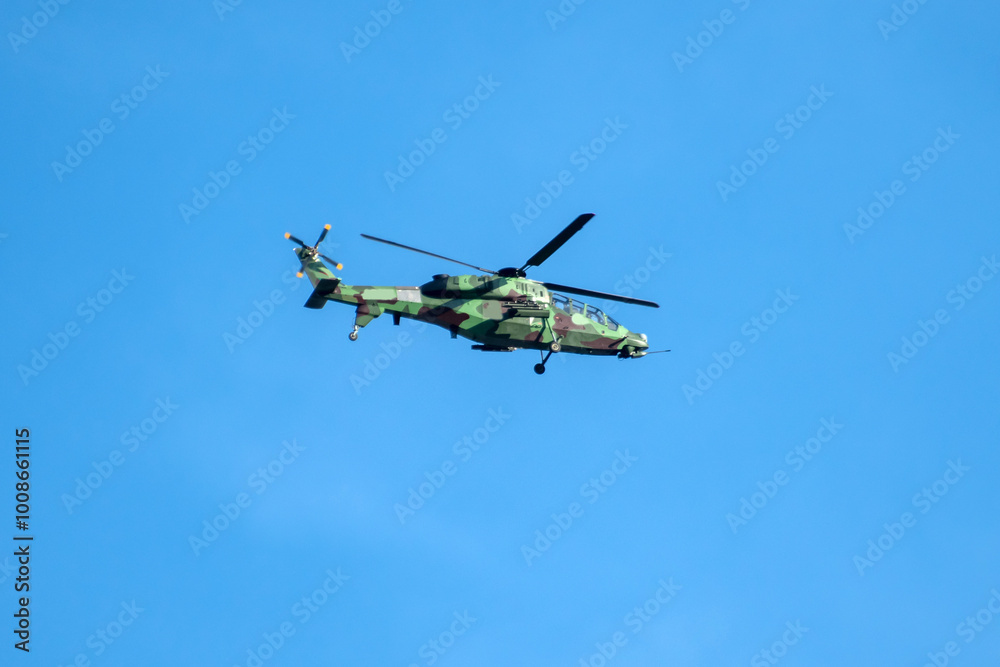 Helicopter is flying on isolated blue sky in mid-air background. Helicopter is flying on isolated blue sky in mid-air background.