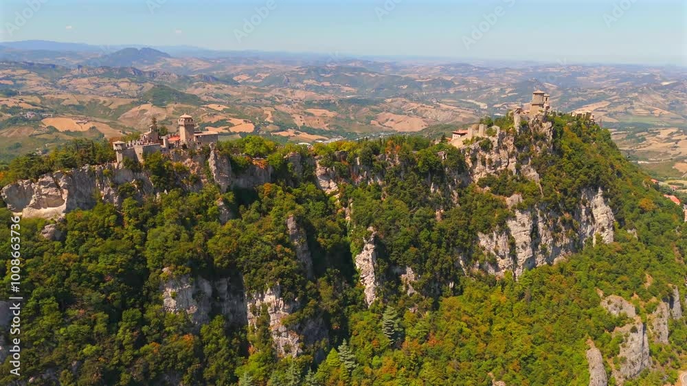 San Marino’s ancient castles dominate the skyline, filmed in breathtaking detail by a sweeping drone. San Marino’s ancient castles dominate the skyline, filmed in breathtaking detail by a sweeping drone.