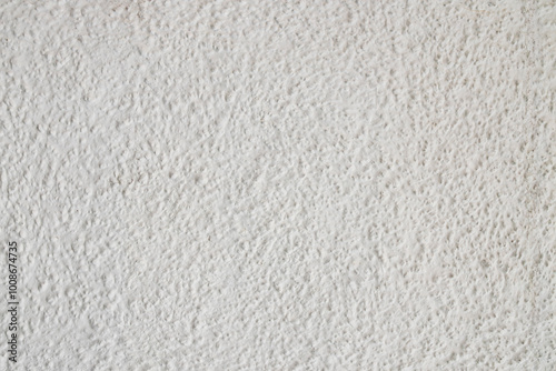 Textured concrete wall background of white painted concrete with small bumps and indentations photo