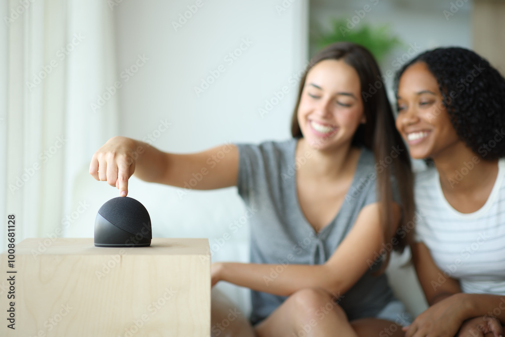 Interracial couple or roommates using smart speaker Interracial couple or roommates using smart speaker
