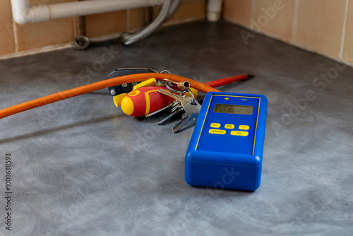 Gas service engineer's digital differential manometer pressure meter on domestic counter top near gas boiler photo