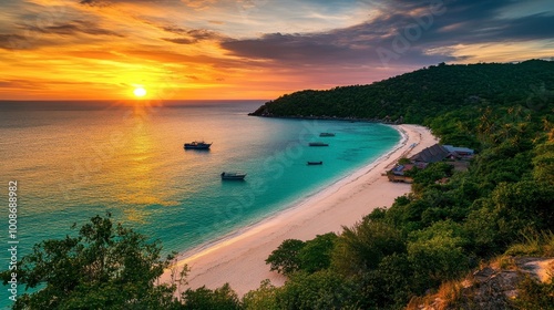 A colorful sunset over Koh Larn, casting a golden glow over the beach and turquoise waters.