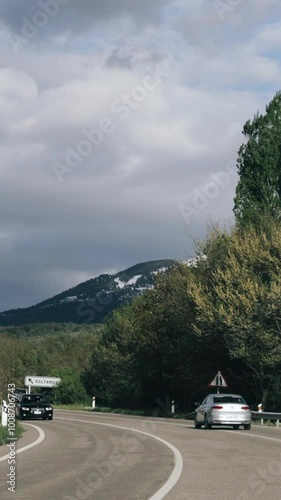 Baltarga, Lerida, Spain. Cars Driving In Beautiful Asphalt Freeway, Motorway, Highway N-1411 Near Traditional Spanish Village Against Background Of Southern Pyrenees Mountains Landscape photo