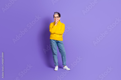 Full length photo of thoughtful positive woman wear yellow sweater smiling empty space isolated violet color background photo