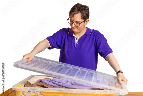 Foto Young student placing lid on plastic storage bins boxes on table ready for back
