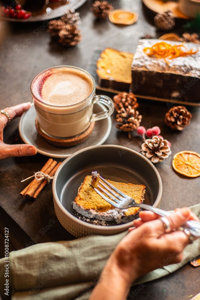 Christmas background with chai latte and homemade carrot cake. Female hand take the cake from the table. Christmas background with chai latte and homemade carrot cake. Female hand take the cake from the table.