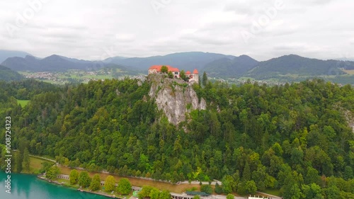 Experience the majestic beauty of Bled Castle from above, where ancient architecture meets the serene waters of Lake Bled, creating a picturesque scene. photo