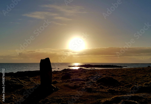 The polochar standing stone at sunset on South Uist, Outer Hebrides, UK photo