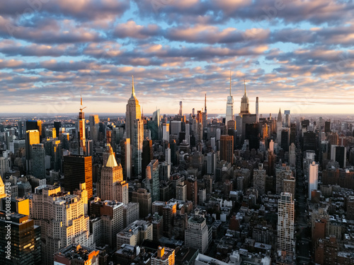 An aerial photo of Manhattan's upper downtown from above during the sunrise clouds in the background. New York, USA
