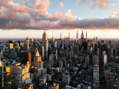 An aerial photo of Manhattan's upper downtown from above during the sunrise clouds in the background. New York, USA photo